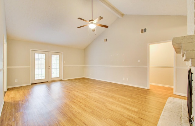 unfurnished living room featuring a brick fireplace, beam ceiling, light hardwood / wood-style floors, and french doors