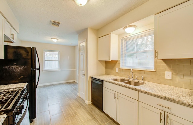 kitchen featuring white cabinets, sink, decorative backsplash, and black appliances