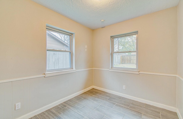 spare room with a textured ceiling