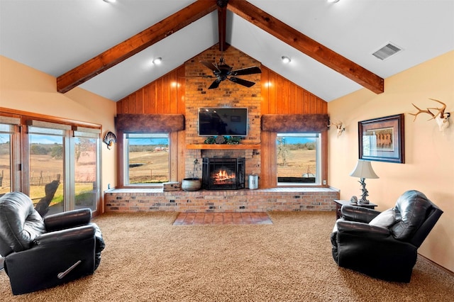 carpeted living room featuring beam ceiling, a fireplace, and high vaulted ceiling