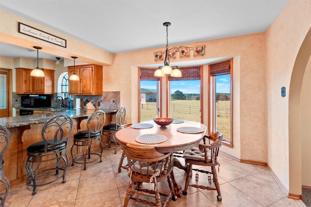 dining area with light tile patterned floors