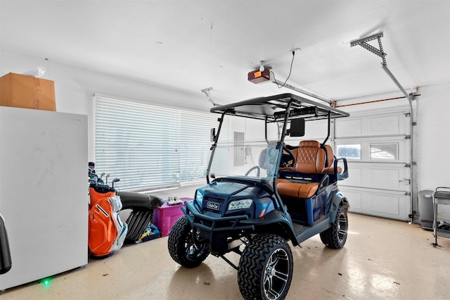 garage with a garage door opener and fridge