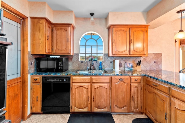 kitchen featuring sink, hanging light fixtures, black appliances, and dark stone counters