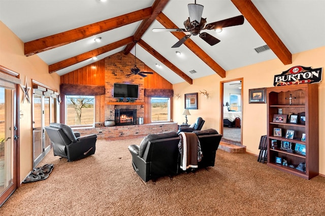 carpeted living room with beam ceiling, a fireplace, and high vaulted ceiling