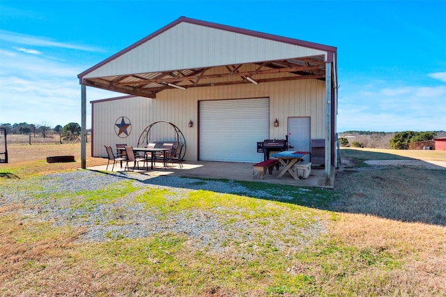 view of outbuilding with a garage and a yard