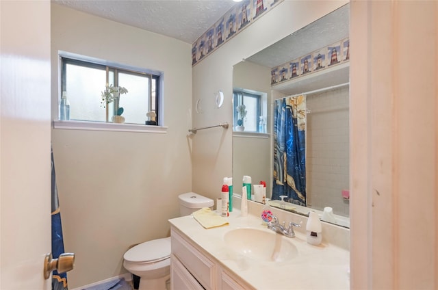 bathroom featuring vanity, toilet, curtained shower, and a textured ceiling