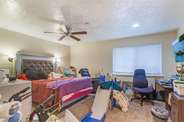 bedroom featuring a textured ceiling, ceiling fan, and carpet floors