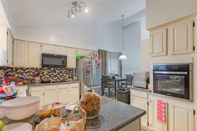 kitchen with tasteful backsplash, stainless steel fridge with ice dispenser, oven, cream cabinets, and a textured ceiling