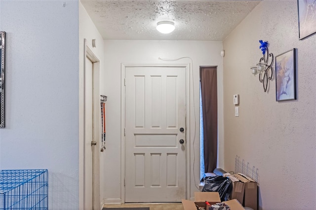 doorway featuring a textured ceiling