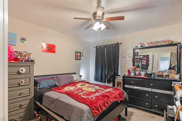 bedroom featuring ceiling fan, light colored carpet, and a textured ceiling