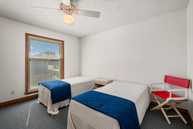 bedroom with a textured ceiling, ceiling fan, and carpet flooring