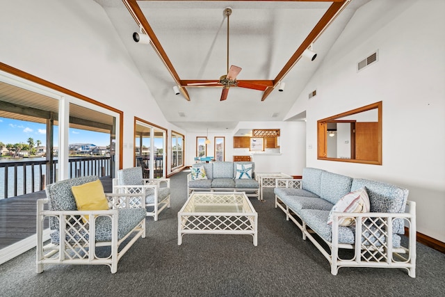 living room featuring rail lighting, a water view, high vaulted ceiling, dark carpet, and ceiling fan