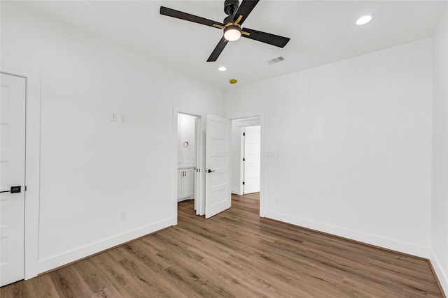 unfurnished bedroom featuring hardwood / wood-style floors and ceiling fan