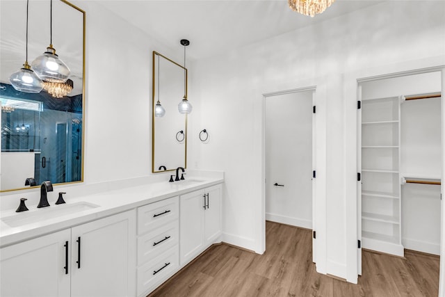 bathroom with vanity, a shower with door, and hardwood / wood-style floors