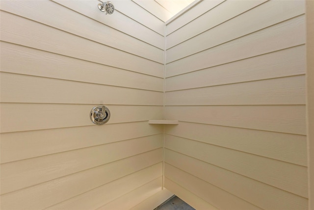 bathroom featuring wood walls