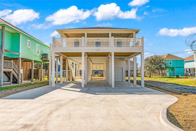 beach home featuring a carport, a garage, and a balcony