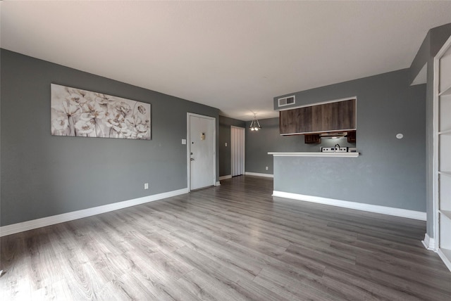 unfurnished living room with hardwood / wood-style flooring