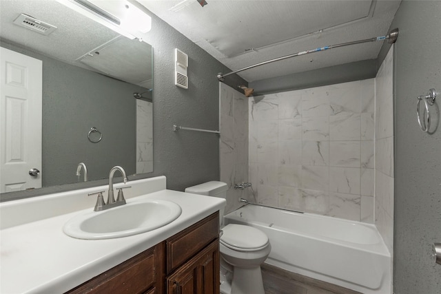 full bathroom featuring hardwood / wood-style floors, toilet, tiled shower / bath, and vanity