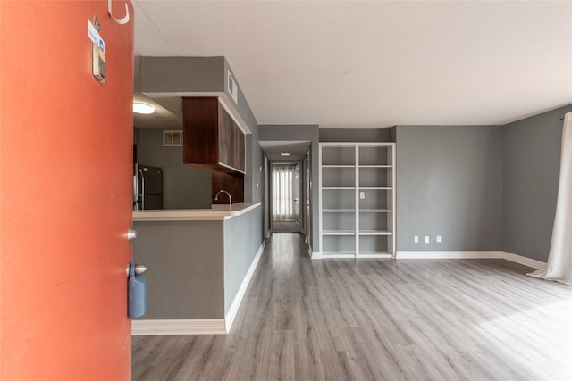 interior space with sink and light hardwood / wood-style flooring