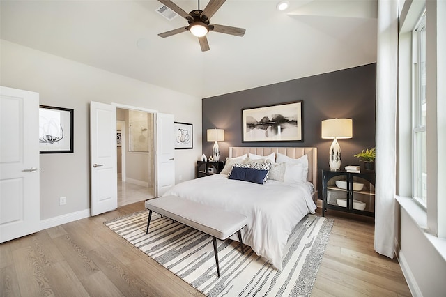 bedroom with light wood-type flooring, baseboards, visible vents, and a ceiling fan