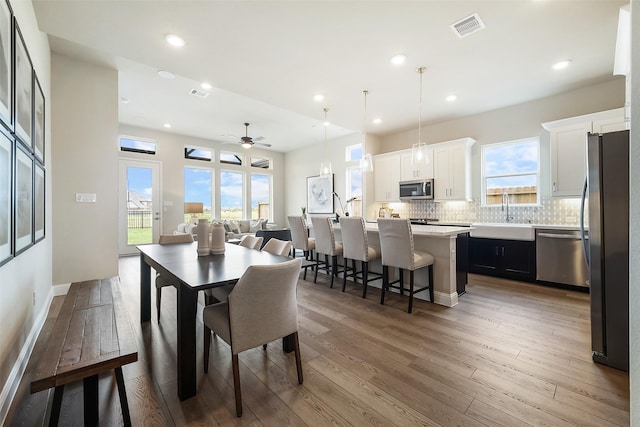 dining space with visible vents, wood finished floors, and recessed lighting