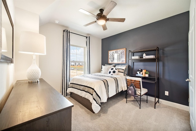 bedroom featuring baseboards, lofted ceiling, a ceiling fan, and light colored carpet