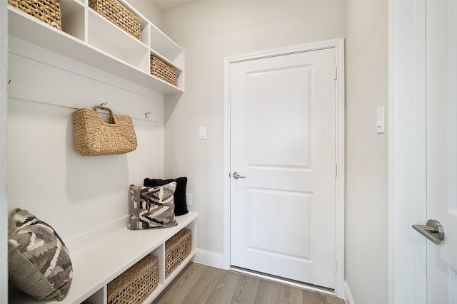 mudroom featuring light wood-style flooring and baseboards