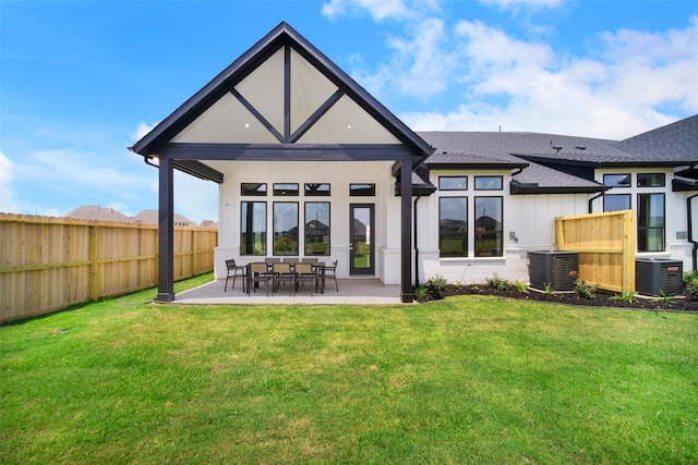 back of property with cooling unit, a patio, fence, and a lawn