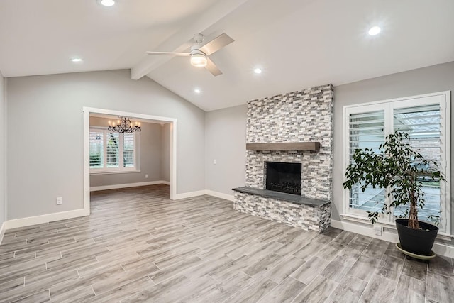 unfurnished living room featuring ceiling fan with notable chandelier, a fireplace, light hardwood / wood-style floors, and lofted ceiling with beams