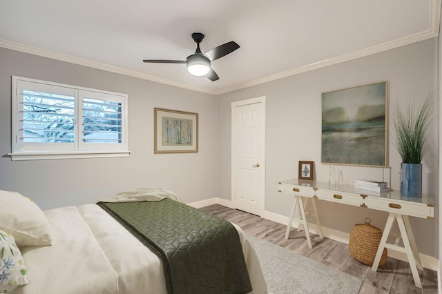 bedroom with crown molding, hardwood / wood-style floors, and ceiling fan