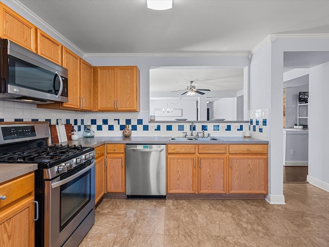 kitchen featuring sink, crown molding, ceiling fan, stainless steel appliances, and tasteful backsplash