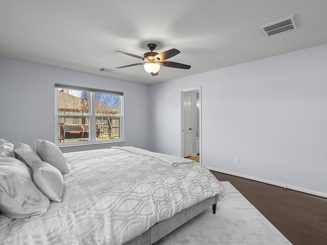 bedroom featuring dark hardwood / wood-style flooring and ceiling fan