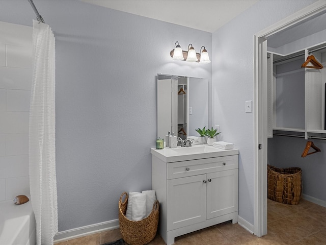 bathroom with shower / tub combo with curtain, vanity, and tile patterned flooring