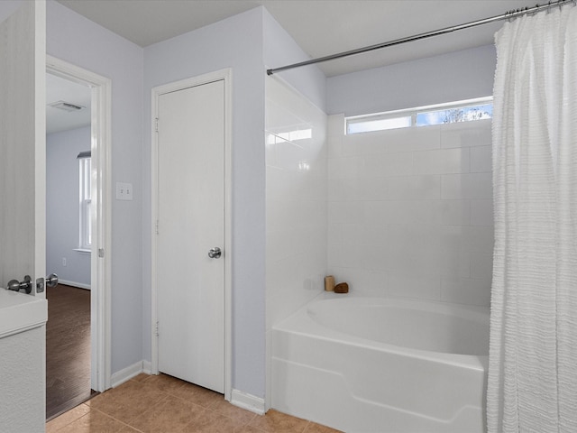 bathroom with tile patterned flooring and shower / bath combination with curtain