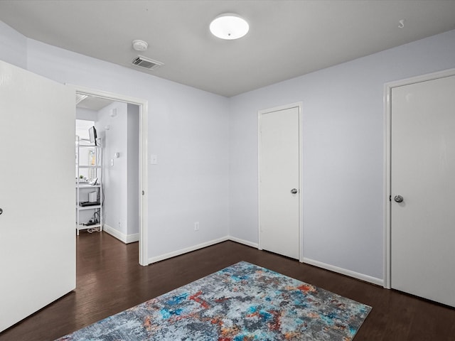 bedroom featuring dark hardwood / wood-style flooring