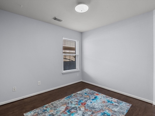 unfurnished room featuring dark wood-type flooring