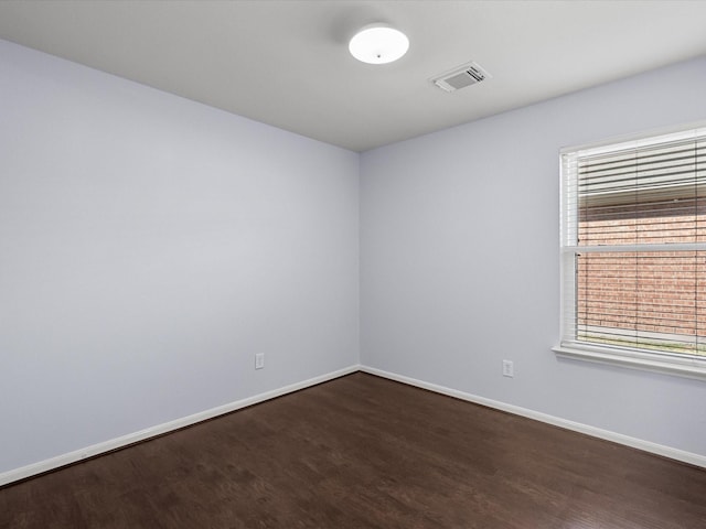 unfurnished room with dark wood-type flooring