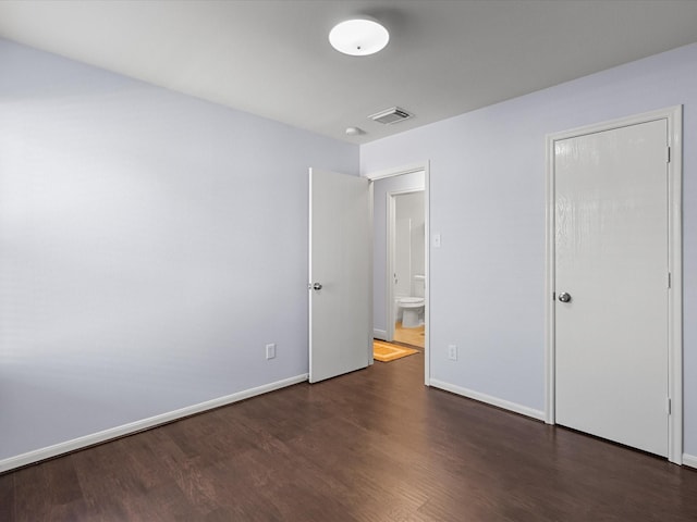 unfurnished bedroom with dark wood-type flooring