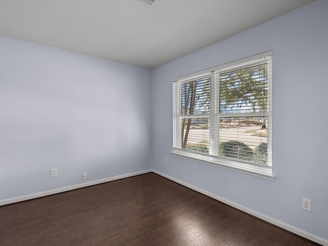 empty room with dark hardwood / wood-style floors