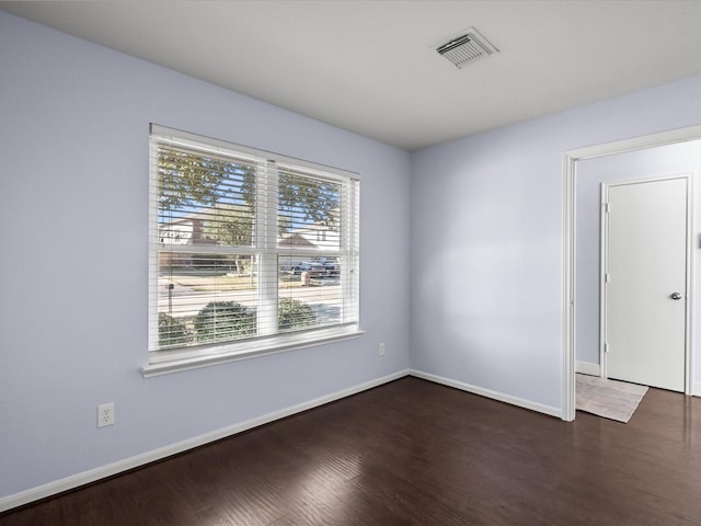 empty room featuring dark wood-type flooring