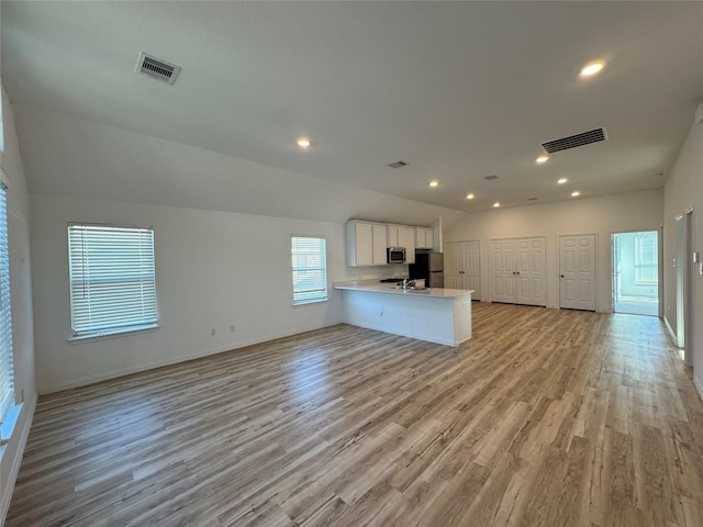 unfurnished living room with light wood-type flooring