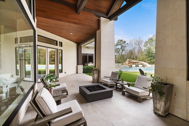 view of patio with a pool and a fire pit