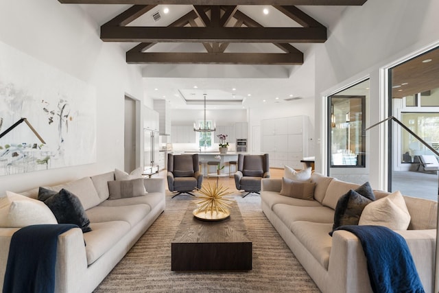 living room featuring beam ceiling and high vaulted ceiling