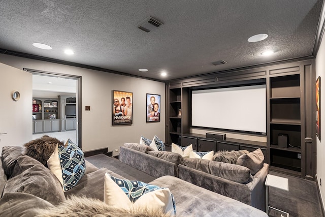 home theater room featuring crown molding, built in features, and a textured ceiling