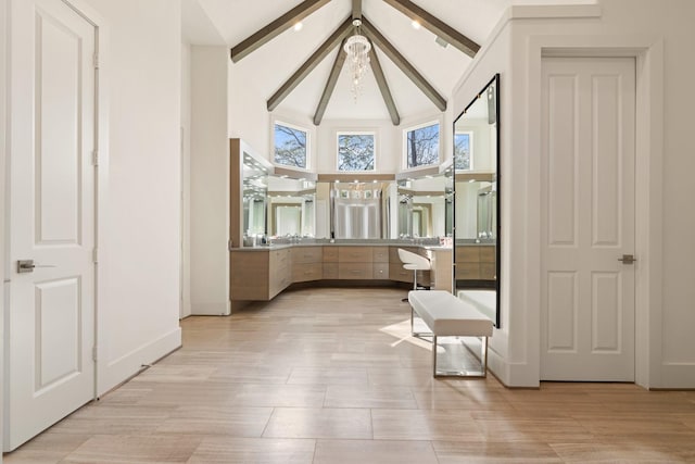 interior space featuring high vaulted ceiling and beamed ceiling