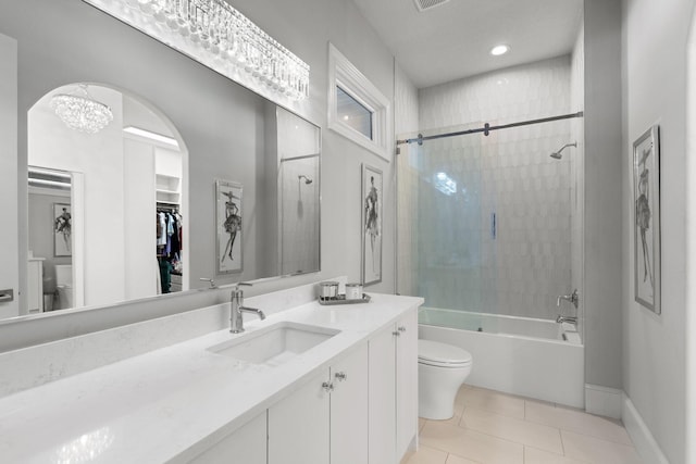 full bathroom with vanity, toilet, tiled shower / bath combo, and tile patterned flooring