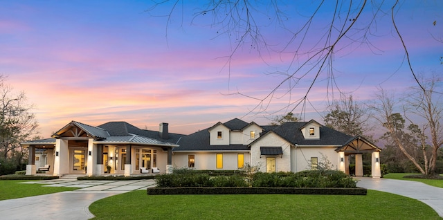 french country home with a lawn and a porch