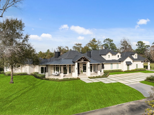 view of front of home featuring a patio area and a front lawn