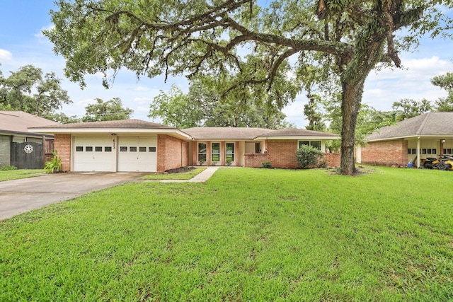 single story home with a garage and a front lawn