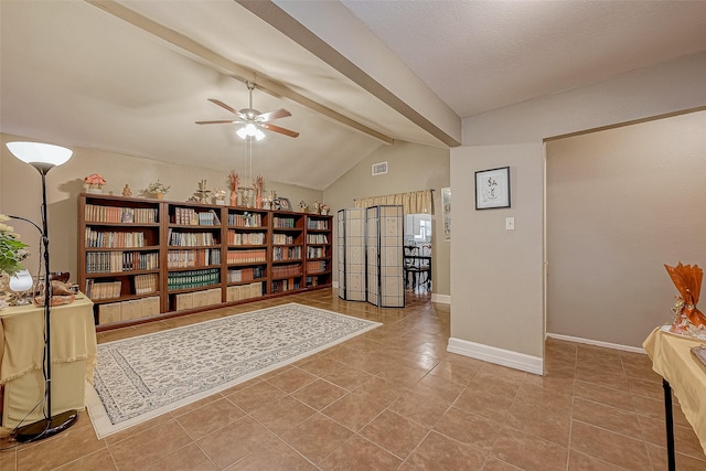 living area with ceiling fan, tile patterned floors, and lofted ceiling with beams